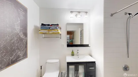 a bathroom with a toilet sink and mirror