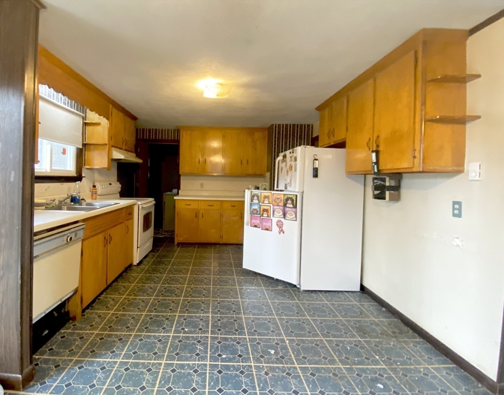 15 Cooper Road Northbridge, MA 01534 - Photo 3 of 22 a kitchen with a sink a stove and refrigerator