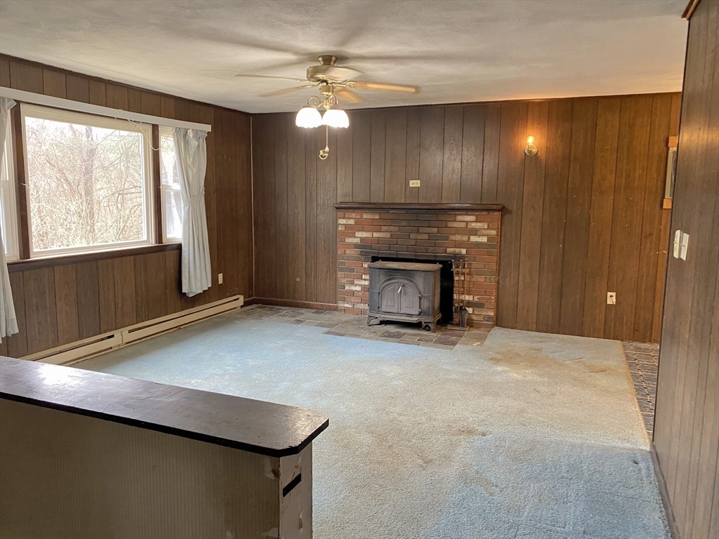 15 Cooper Road Northbridge, MA 01534 - Photo 7 of 22 a view of an empty room with a fireplace and a window