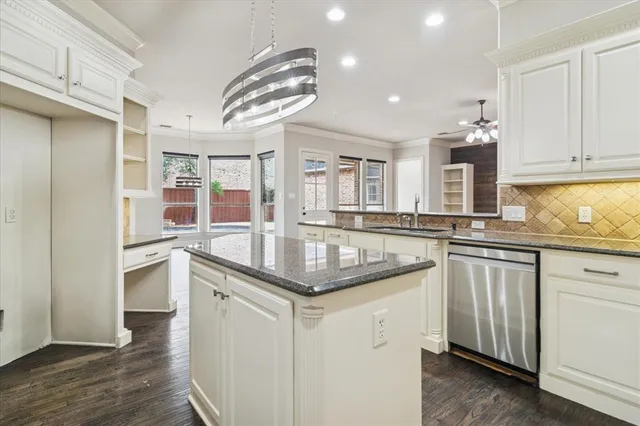 a kitchen with stainless steel appliances granite countertop a sink and dishwasher a stove with wooden floor