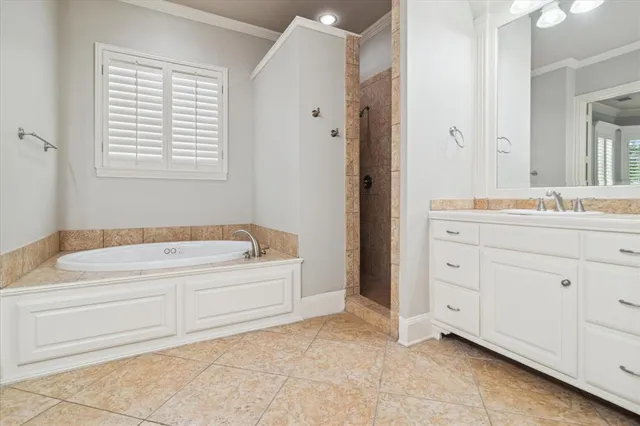a spacious bathroom with a tub sink and mirror