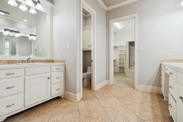 a spacious bathroom with a mirror sink and shower