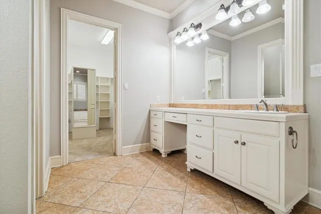 a spacious en suite bathroom with a double vanity sink a mirror and a shower