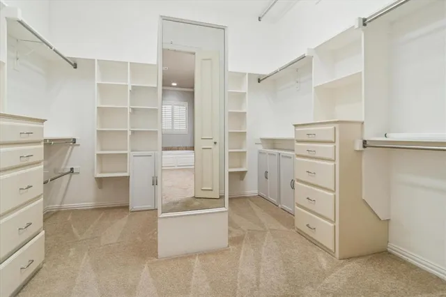 a view of walk in closet and bedroom