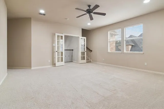 an empty room with a empty space and windows