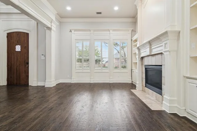wooden floor in an empty room with a fireplace