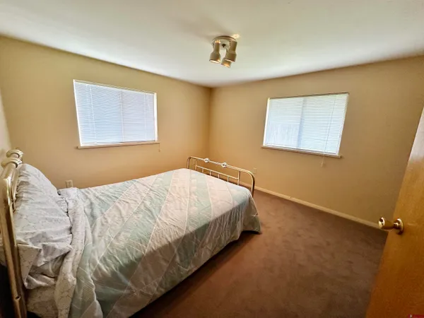 a bed sitting in a bedroom next to a blue wall
