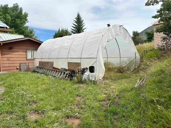 a backyard of a house with table and chairs