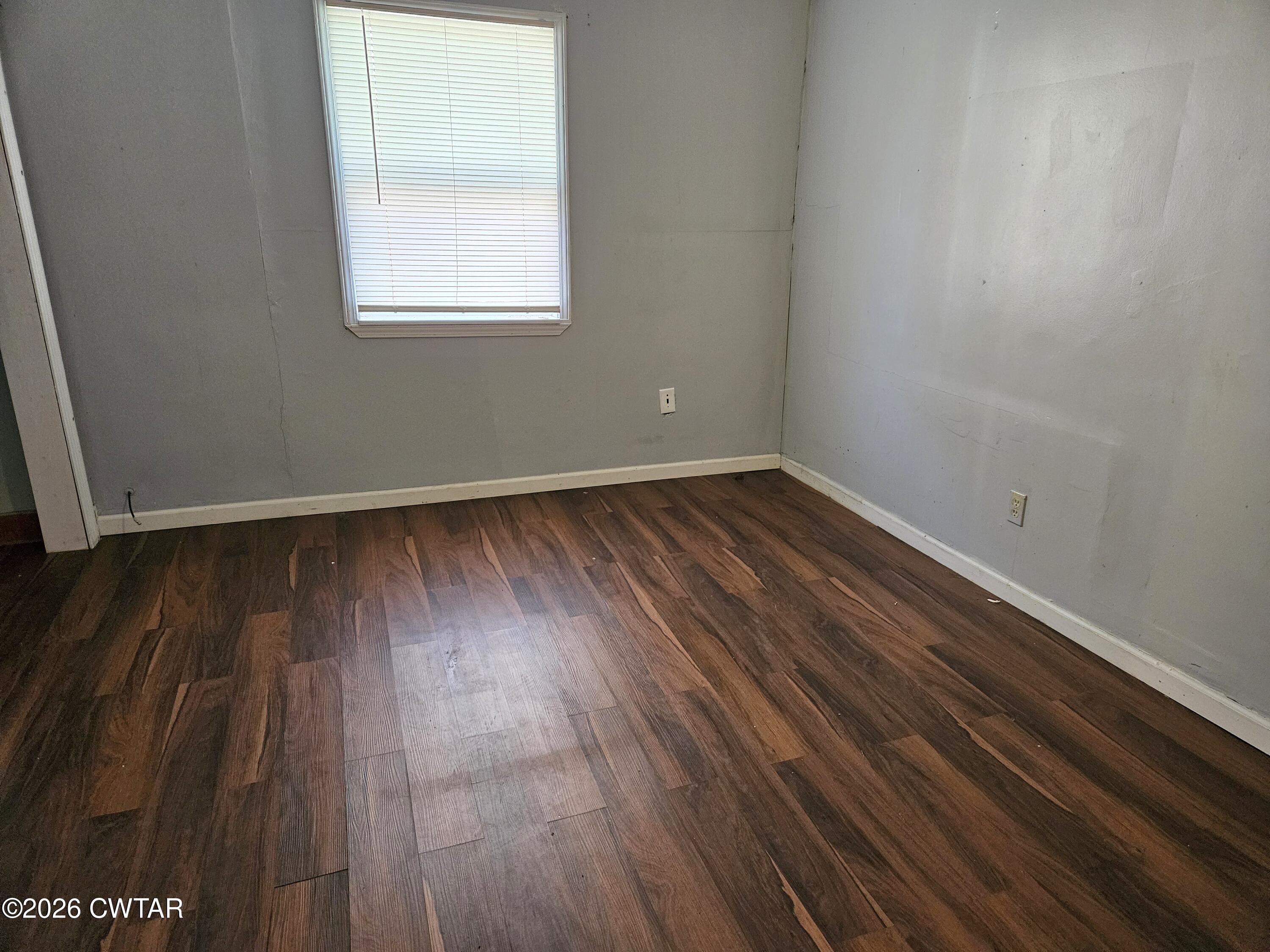 32 Russell Road Jackson, TN 38301 - Photo 11 of 15 an empty room with wooden floor and windows