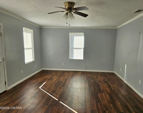 a view of a room with wooden floor and window