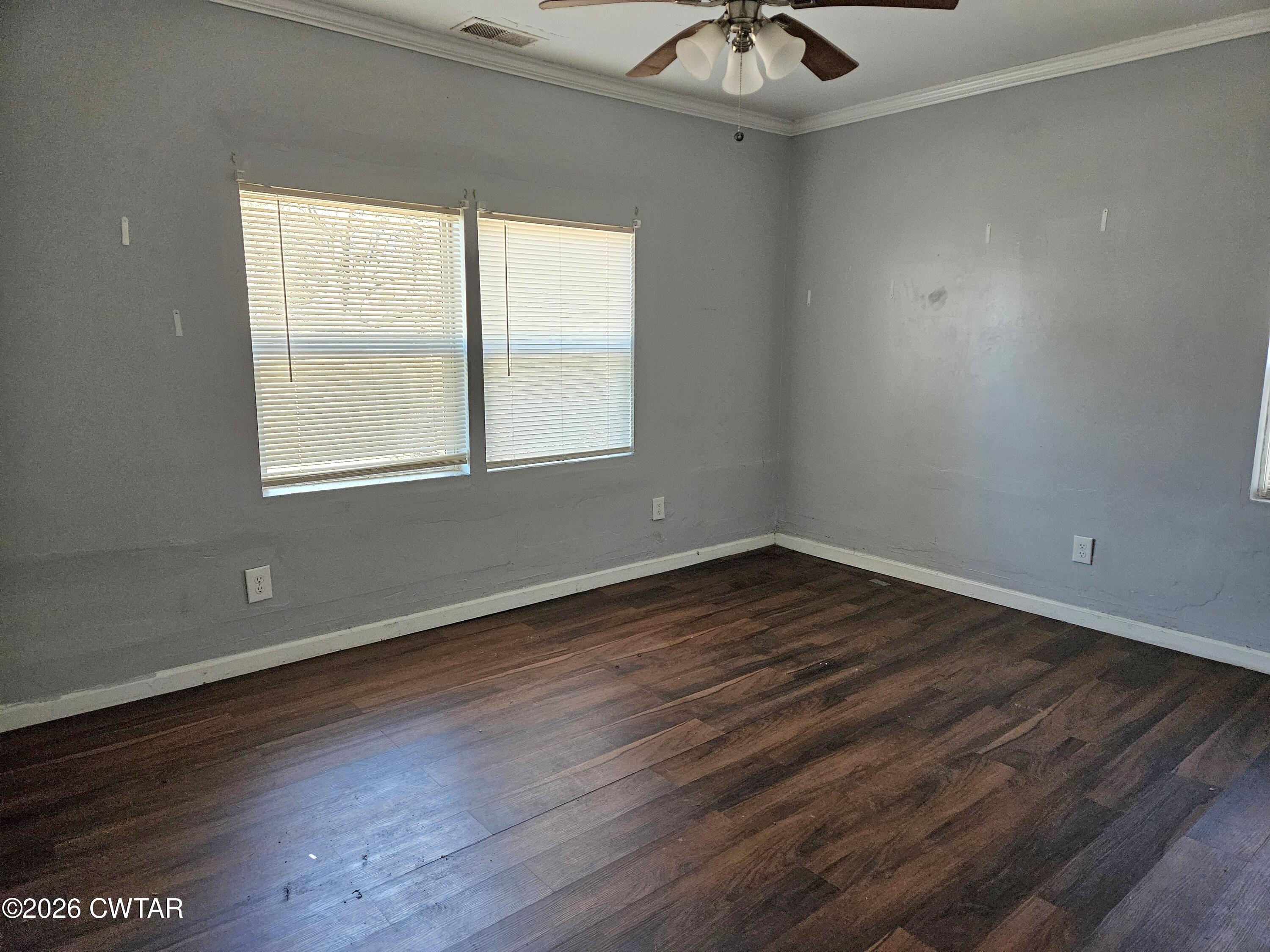 32 Russell Road Jackson, TN 38301 - Photo 9 of 15 an empty room with wooden floor and windows