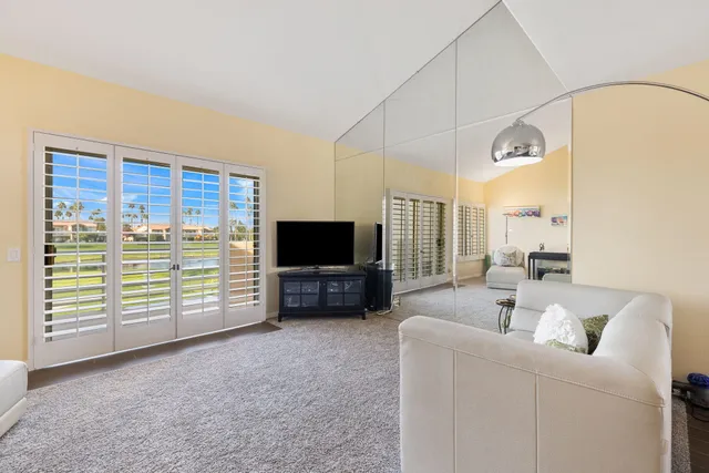 a view of a swimming pool and lounge chairs