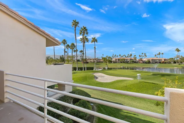 a living room with furniture a flat screen tv and a floor to ceiling window