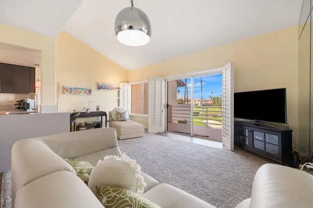 a view of a swimming pool with outdoor seating