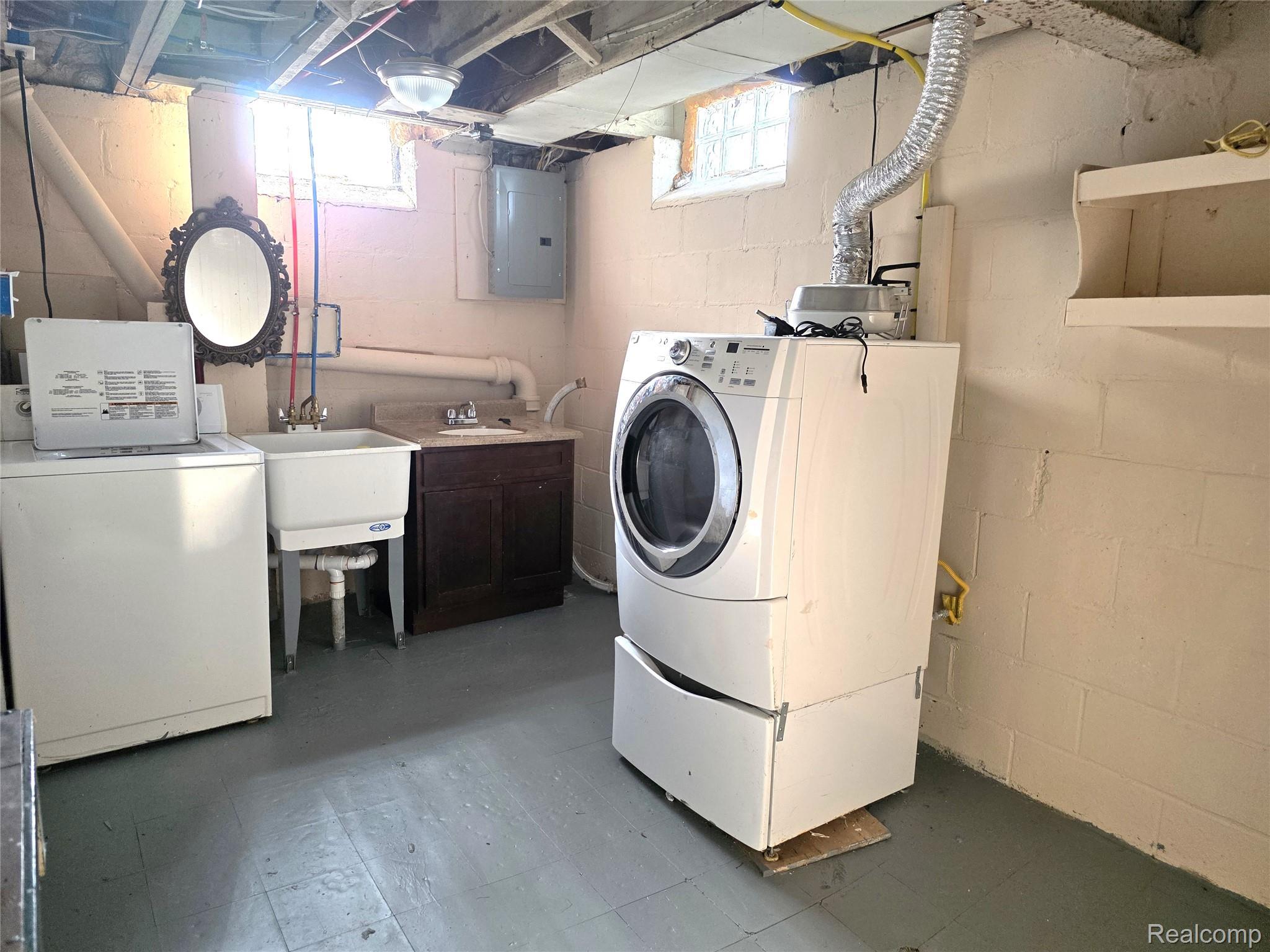 16814 Strathmoor Street Detroit, MI 48235 - Photo 25 of 31 Laundry area featuring a utility sink, dark wood-finish vanity with countertop, painted concrete block walls, and exposed ceiling joists
