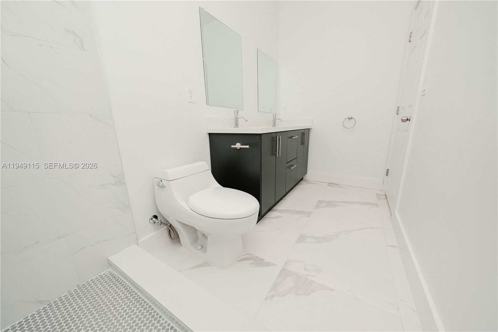 820 Northwest 18th Avenue Pompano Beach, FL 33069 - Photo 17 of 46 a white toilet sitting next to a white sink