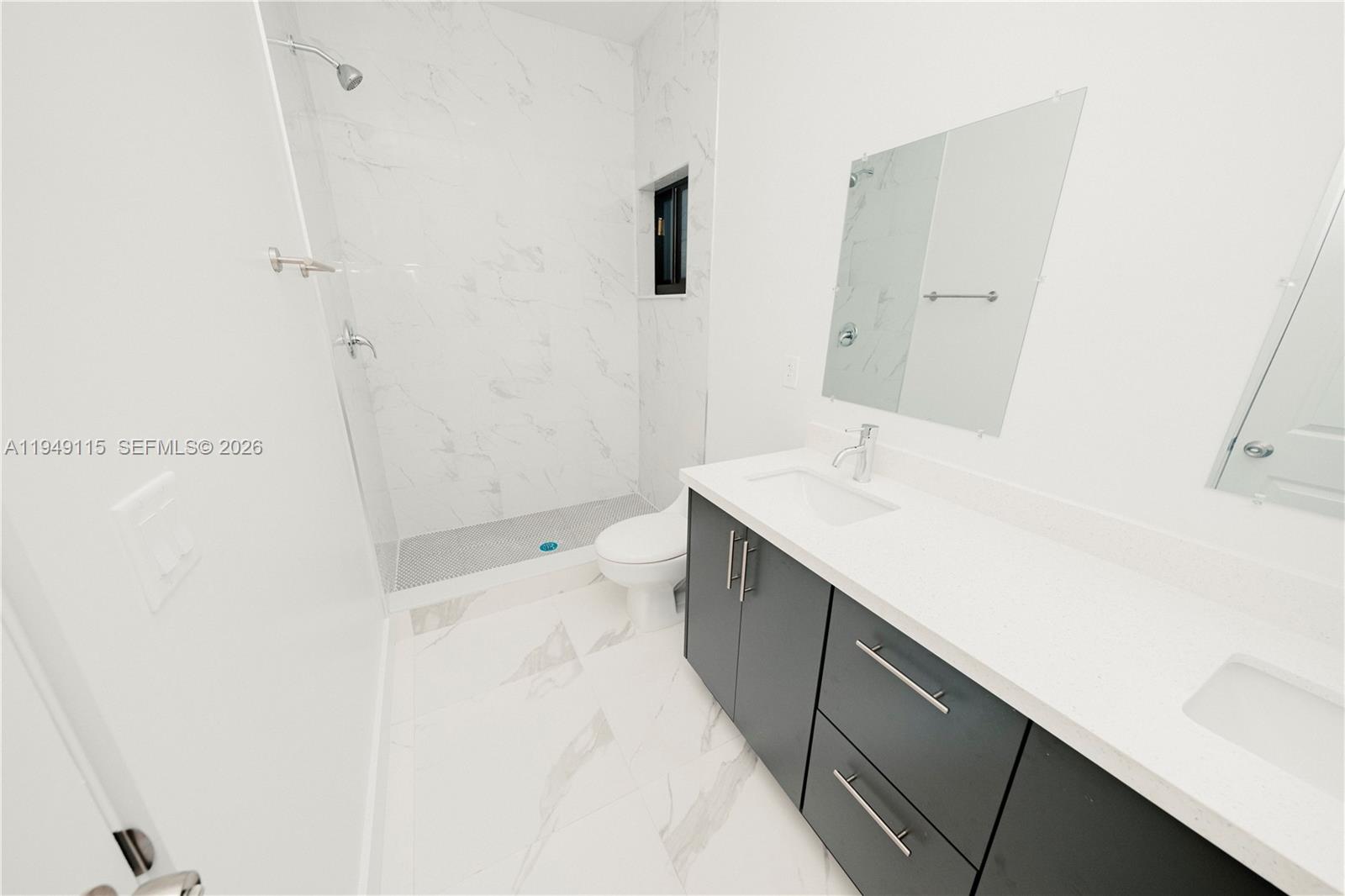 820 Northwest 18th Avenue Pompano Beach, FL 33069 - Photo 18 of 46 a bathroom with a sink a toilet and shower