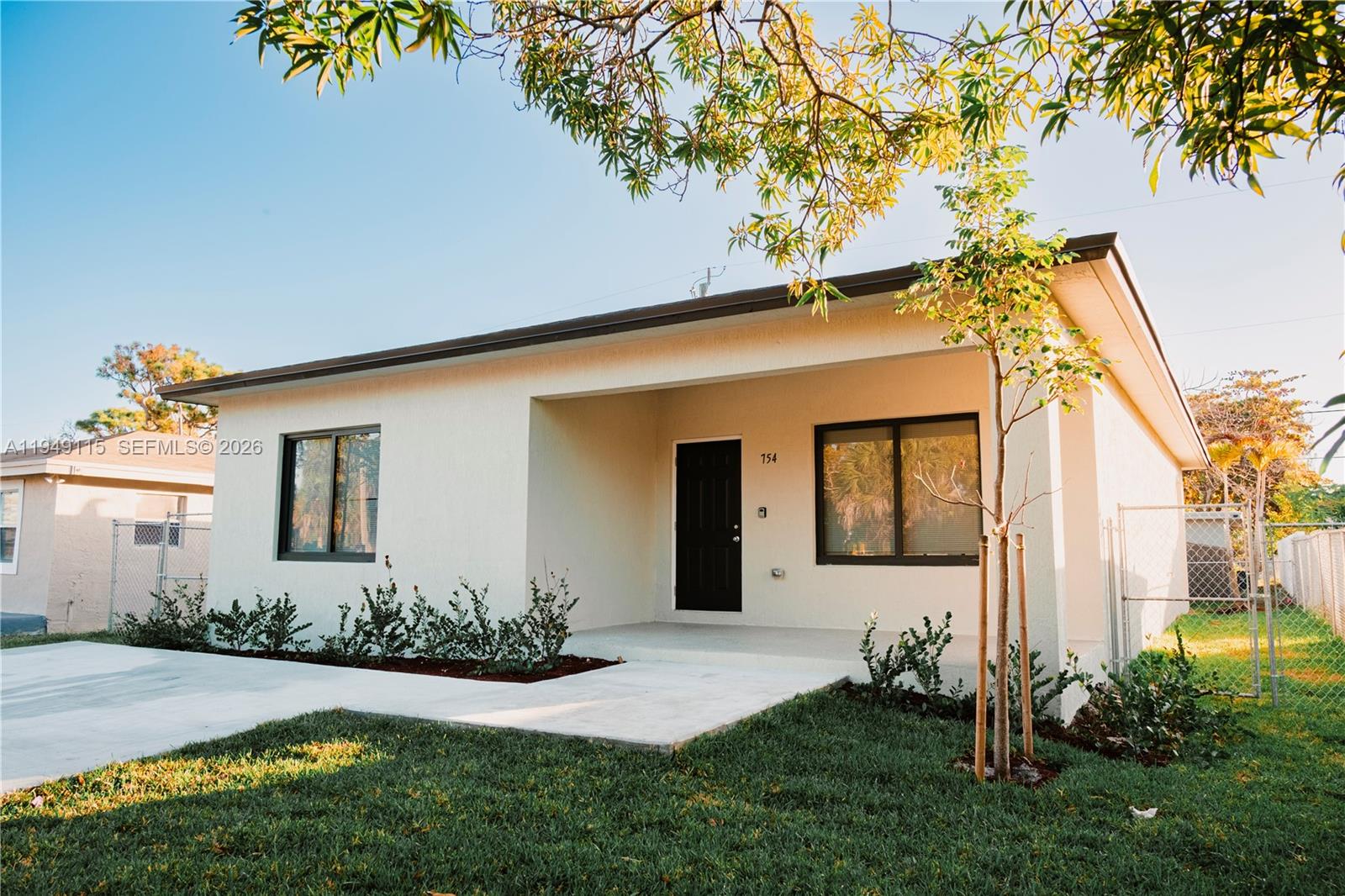 820 Northwest 18th Avenue Pompano Beach, FL 33069 - Photo 2 of 46 a front view of a house with garden