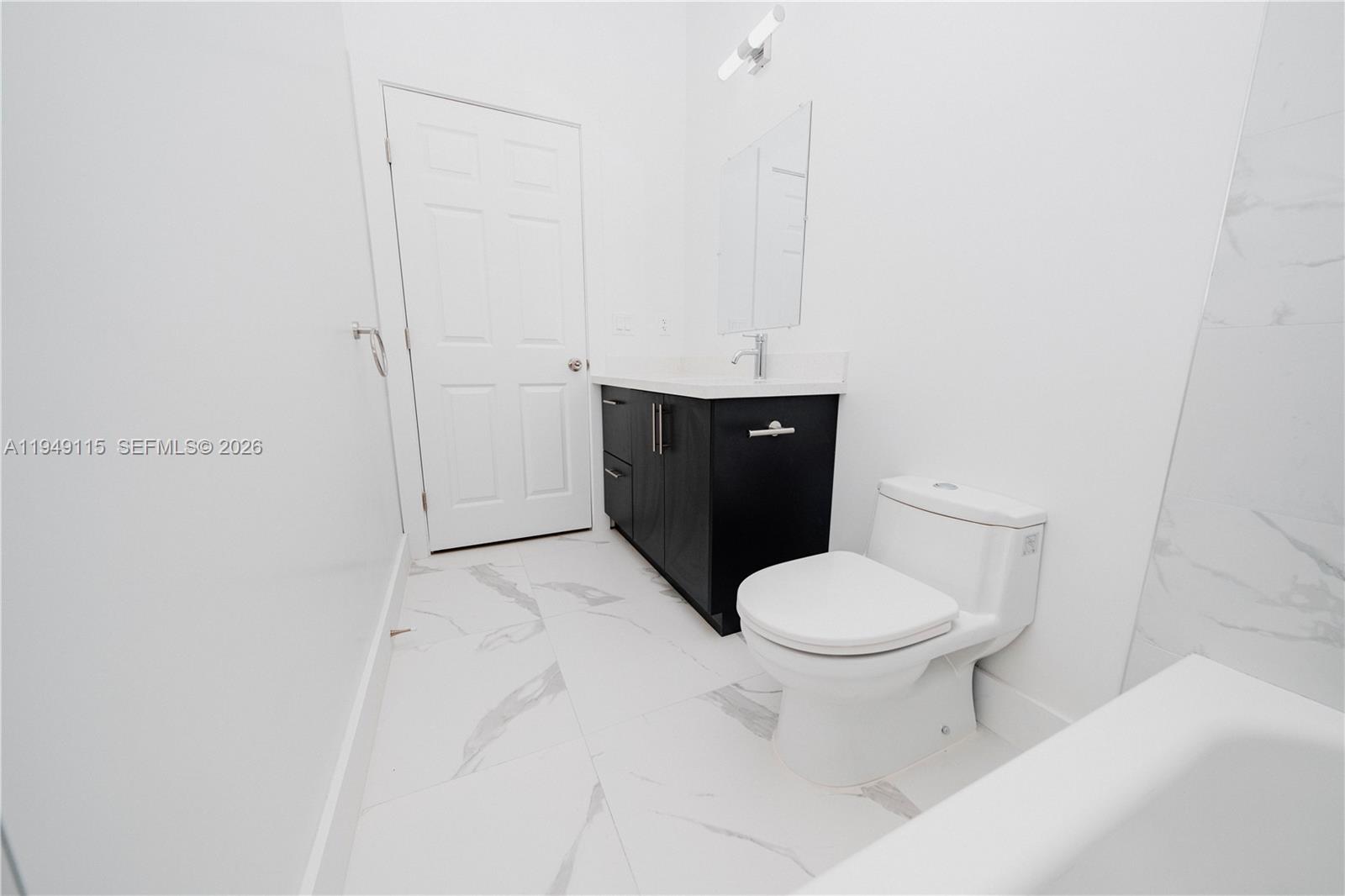820 Northwest 18th Avenue Pompano Beach, FL 33069 - Photo 23 of 46 a bathroom with a sink and a toilet