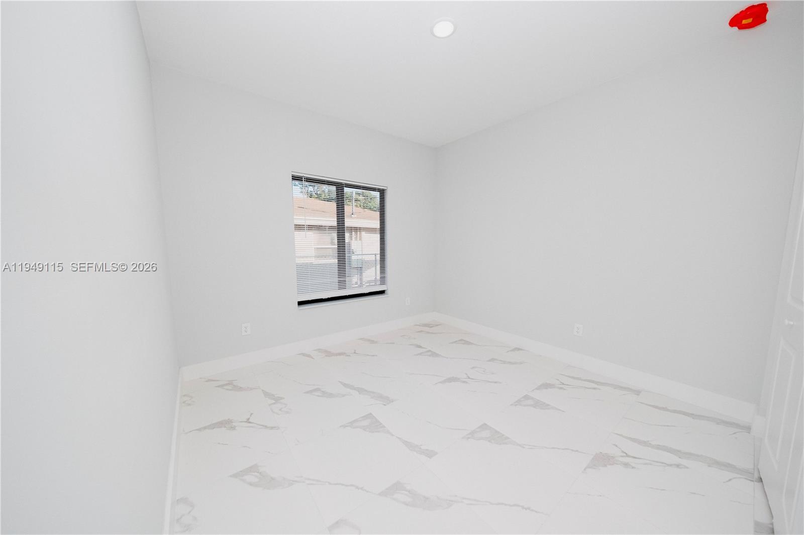 820 Northwest 18th Avenue Pompano Beach, FL 33069 - Photo 24 of 46 an empty room with windows
