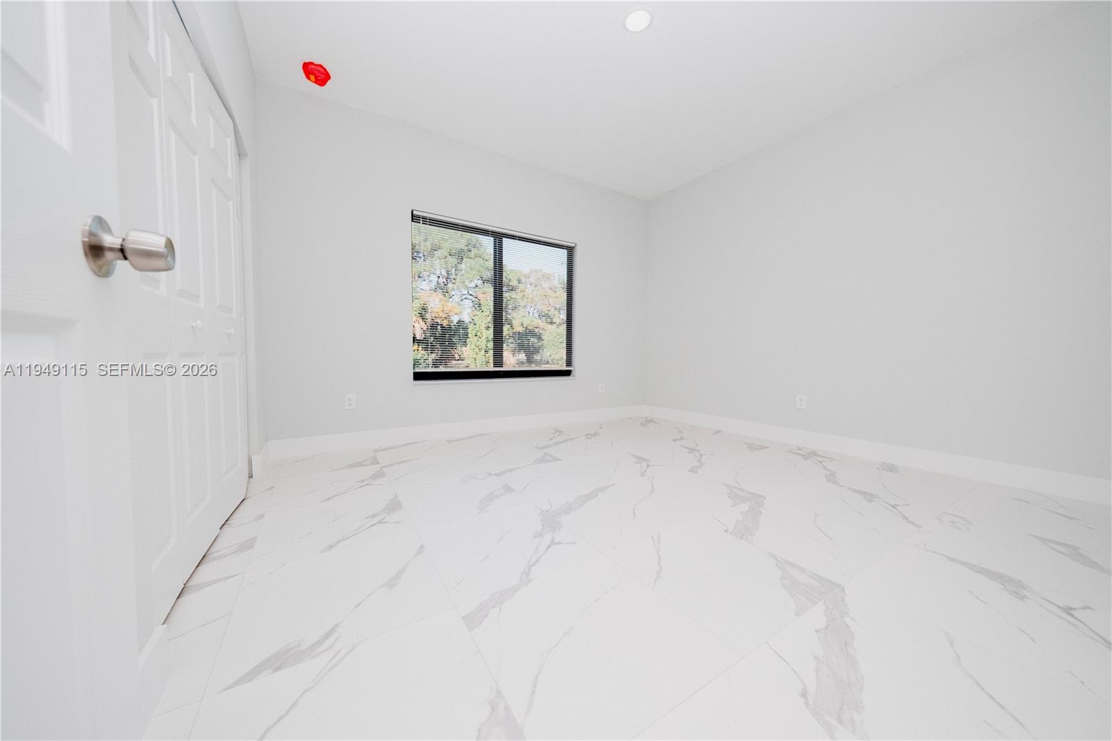 820 Northwest 18th Avenue Pompano Beach, FL 33069 - Photo 32 of 46 an empty room with windows