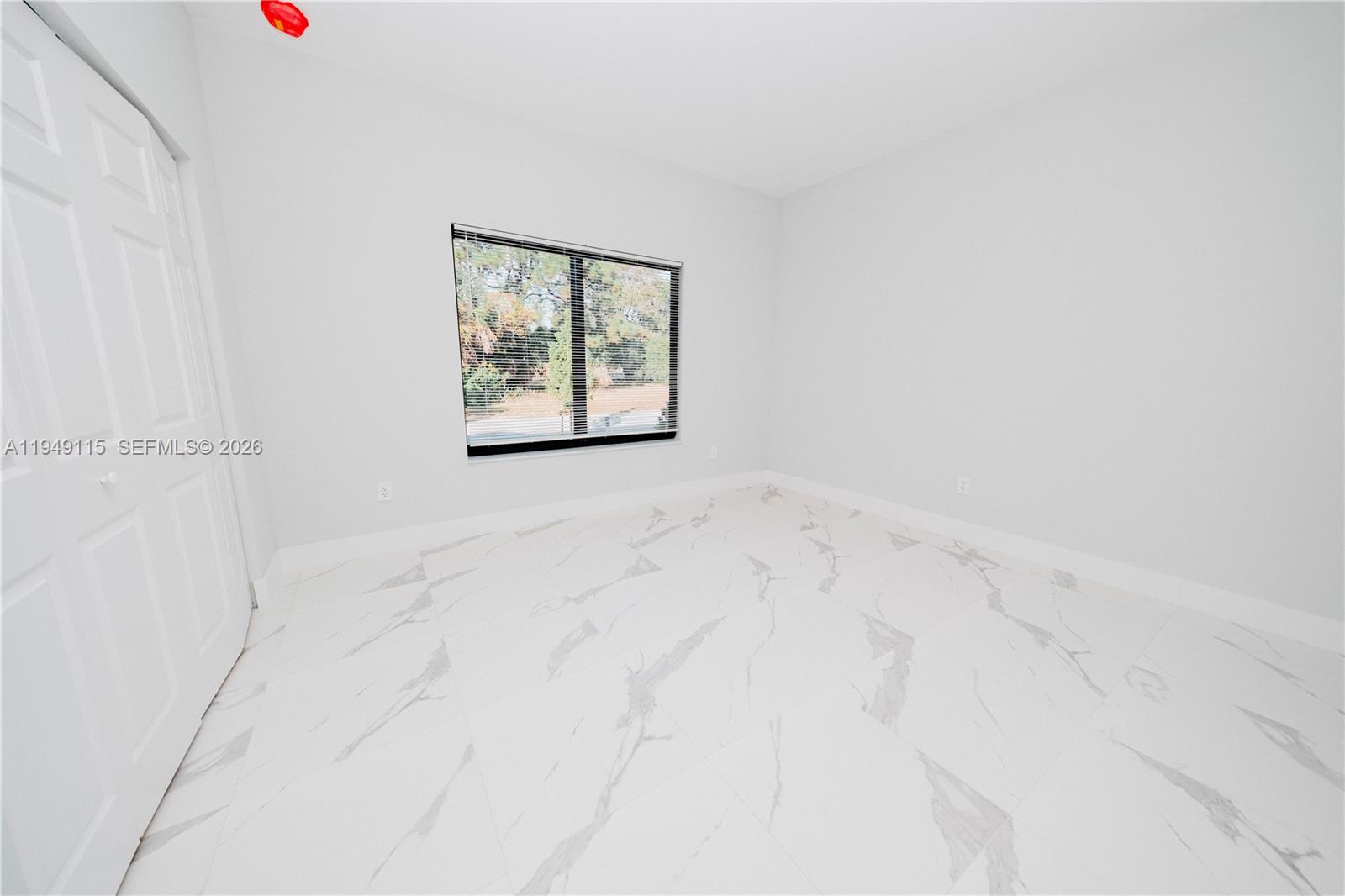 820 Northwest 18th Avenue Pompano Beach, FL 33069 - Photo 33 of 46 an empty room with a window