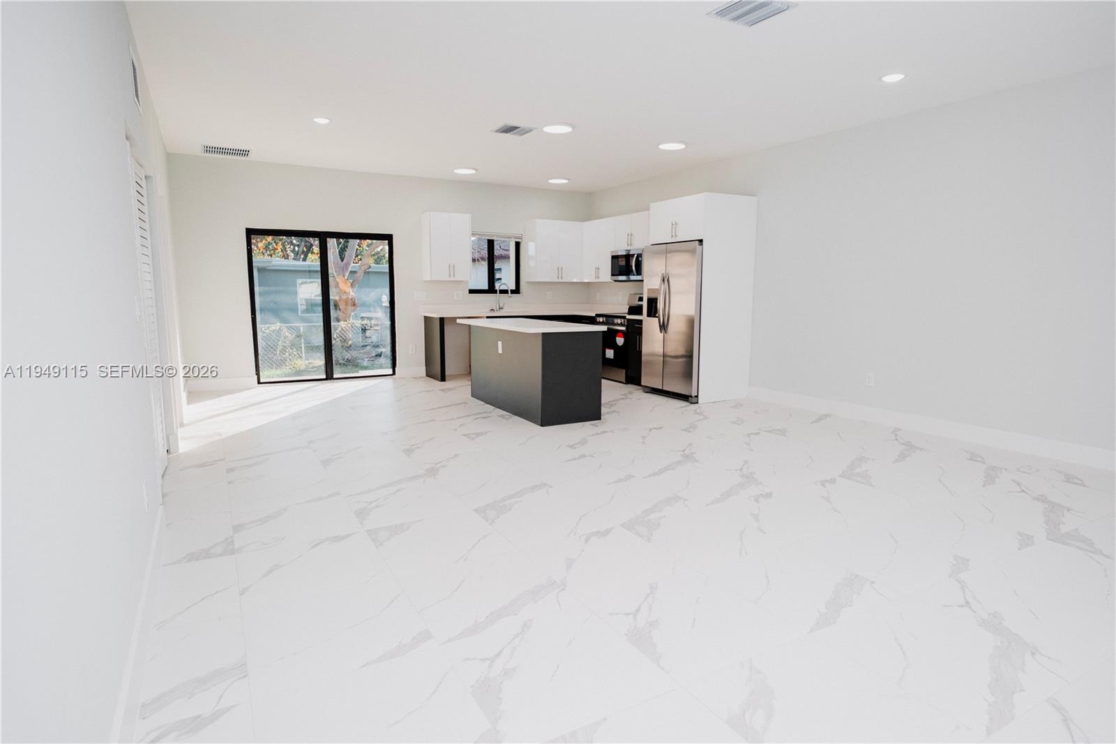 820 Northwest 18th Avenue Pompano Beach, FL 33069 - Photo 43 of 46 an empty room with a cabinet and kitchen view