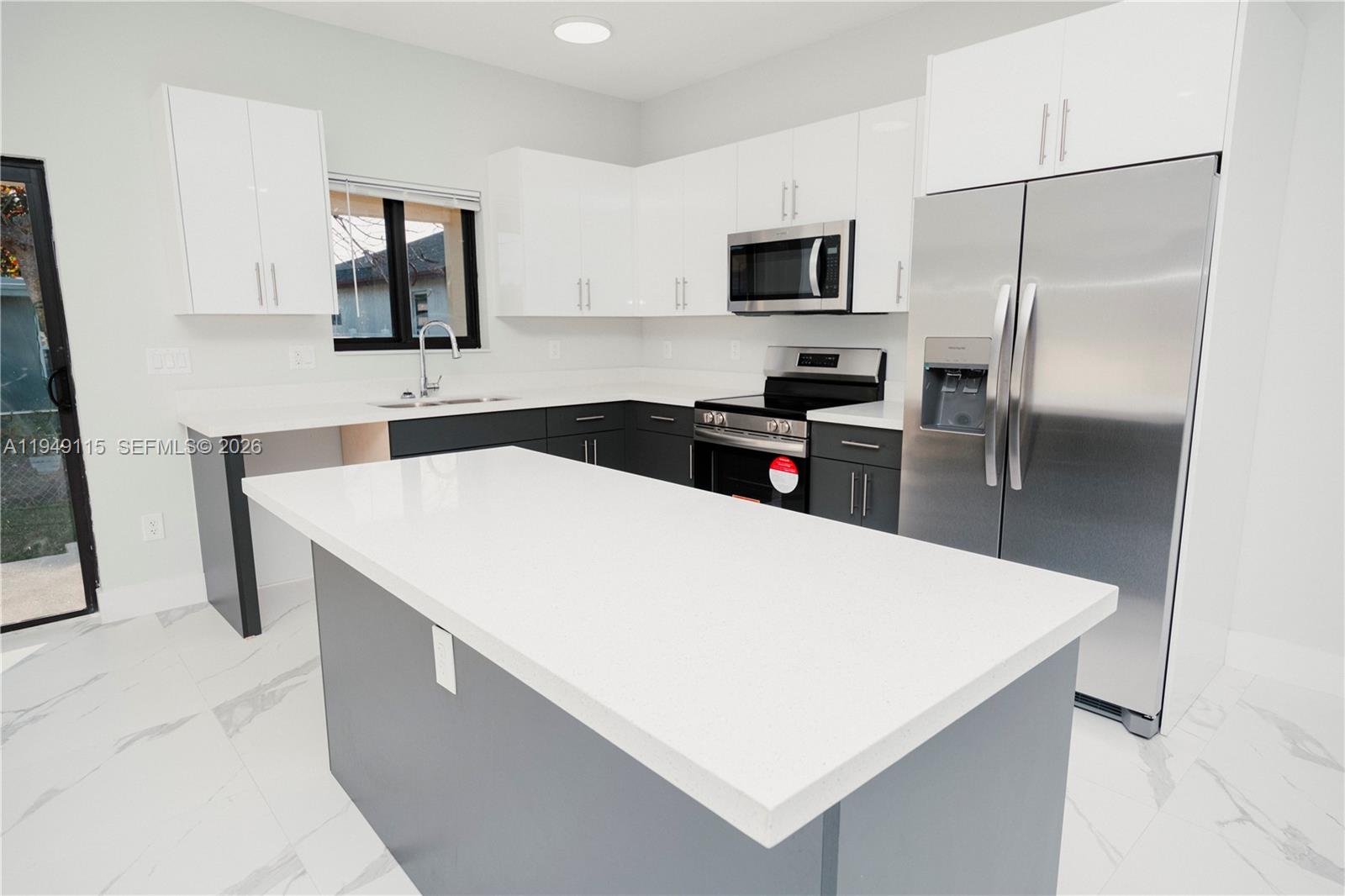820 Northwest 18th Avenue Pompano Beach, FL 33069 - Photo 9 of 46 a kitchen with a appliances a sink and a refrigerator