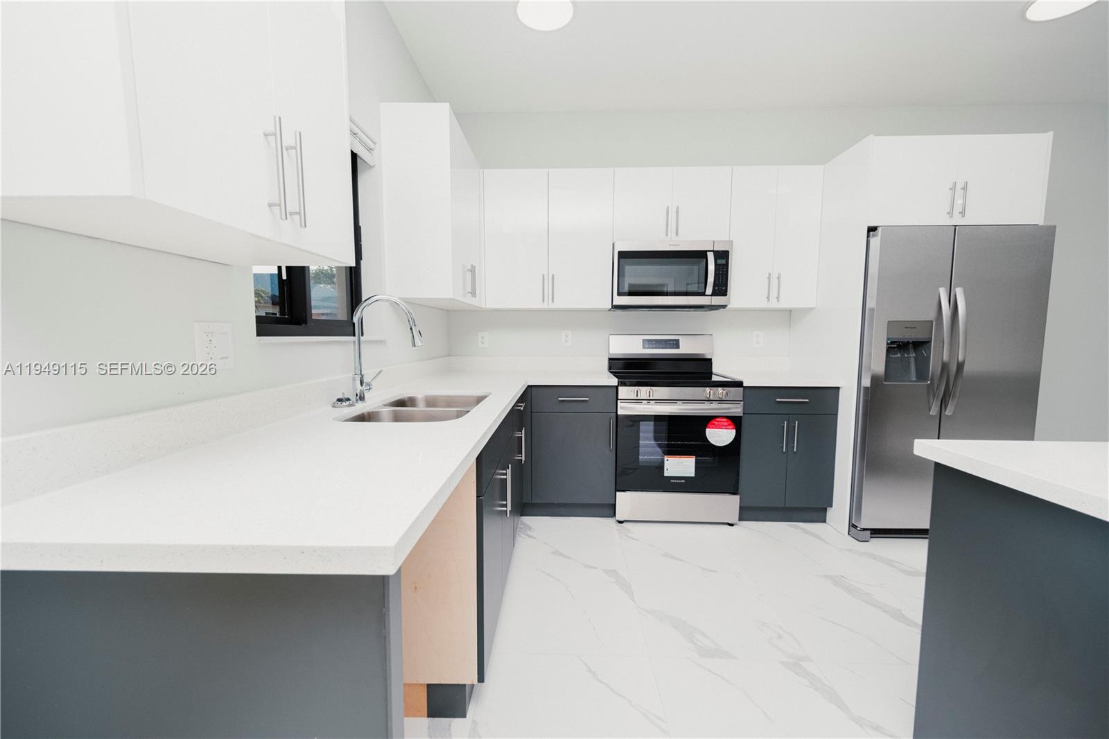 820 Northwest 18th Avenue Pompano Beach, FL 33069 - Photo 10 of 46 a kitchen with a sink a stove and refrigerator