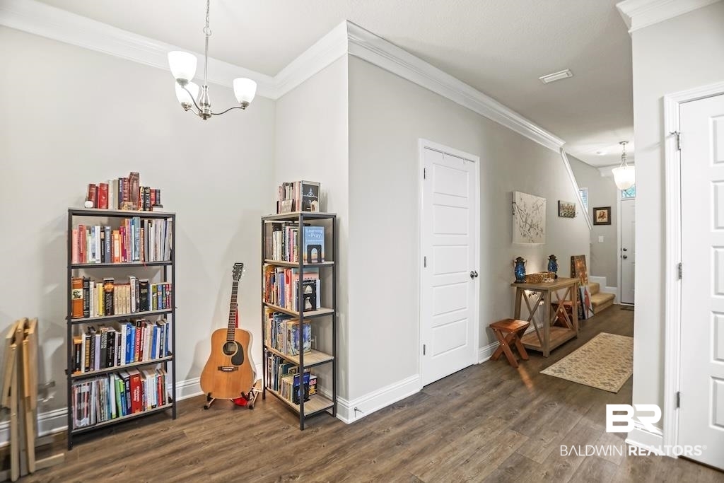 25806 Pollard Road, Unit 27 Daphne, AL 36526 - Photo 20 of 46 Sitting room with ornamental molding, dark wood-style flooring, and suspended lighting