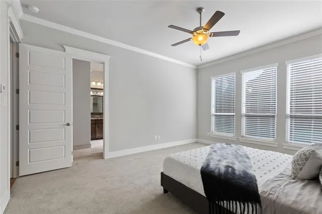 a bedroom with a bed and a ceiling fan