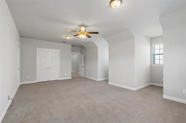 an empty room with a window and a chandelier