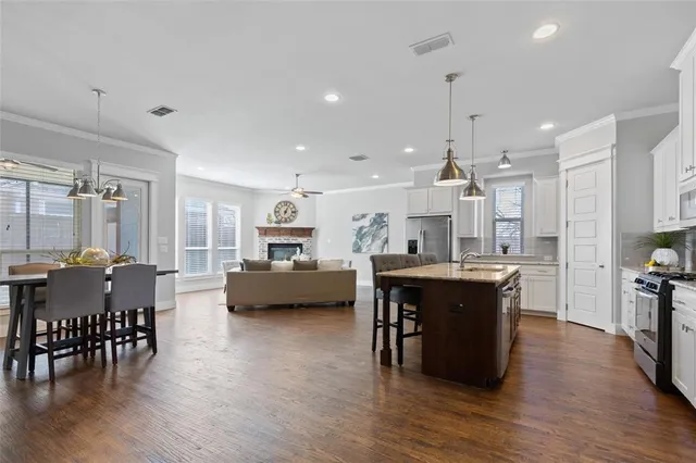 a view of a dining room with furniture and wooden floor