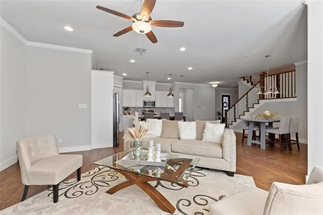 a kitchen with stainless steel appliances granite countertop a dining table chairs sink and cabinets
