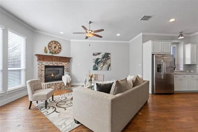 a living room with furniture a chandelier and a window