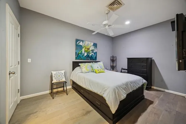 a bedroom with a bed table and window