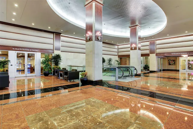 a living room with furniture and a glass door