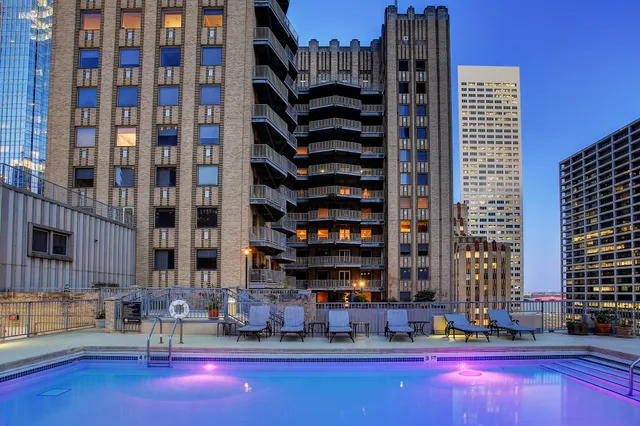 a swimming pool with outdoor seating and yard