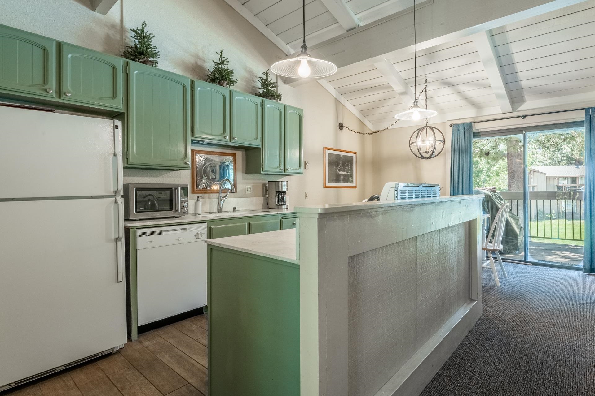 3252 Chateau Road, Unit 18 Mammoth Lakes, CA 93546 - Photo 7 of 30 Kitchen area with green cabinetry, white appliances, and wood-finish flooring