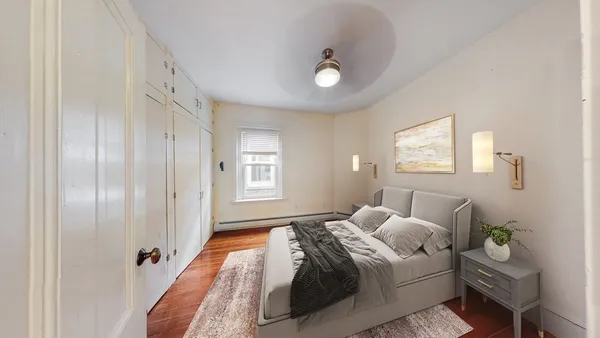 a bedroom with bed and window