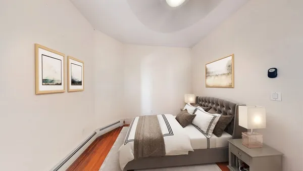 a bedroom with a bed and a lamp
