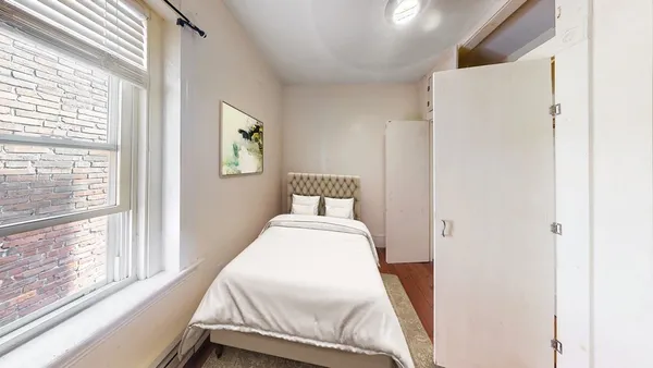 a bedroom with a bed and window