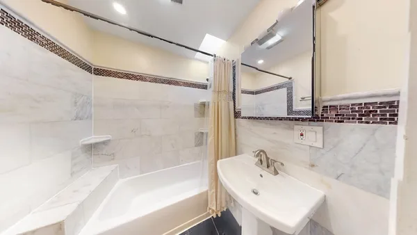 a bathroom with a bathtub and a sink