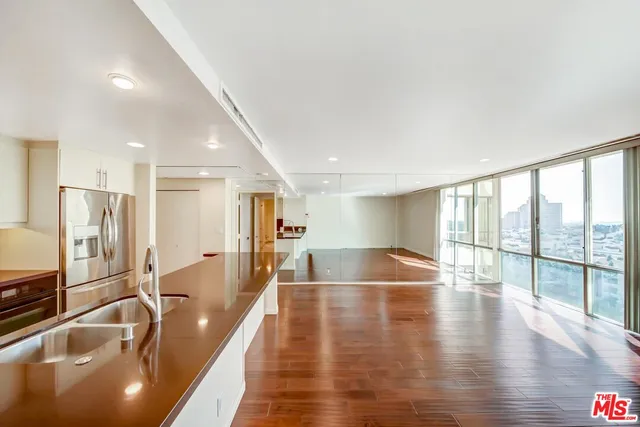a lobby with a floor to ceiling window and wooden floor