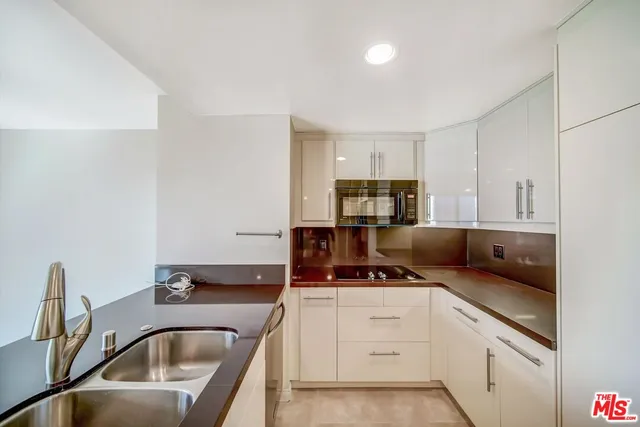 a kitchen with a sink cabinets and appliances