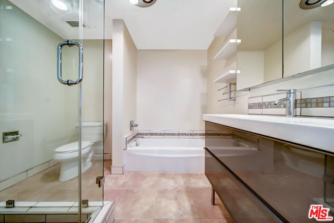 2160 Century Park, Unit 1503 Los Angeles, CA 90067 - Photo 16 of 22 a bathroom with a sink a toilet and shower