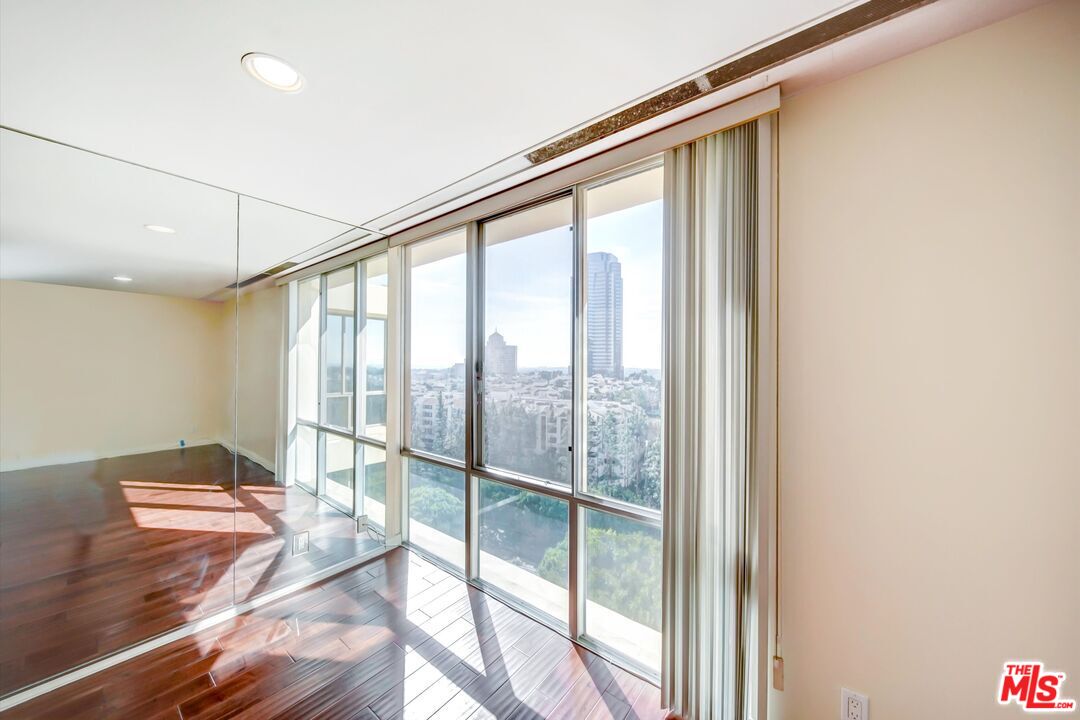 2160 Century Park, Unit 1503 Los Angeles, CA 90067 - Photo 8 of 22 a bedroom with a bed and a large window