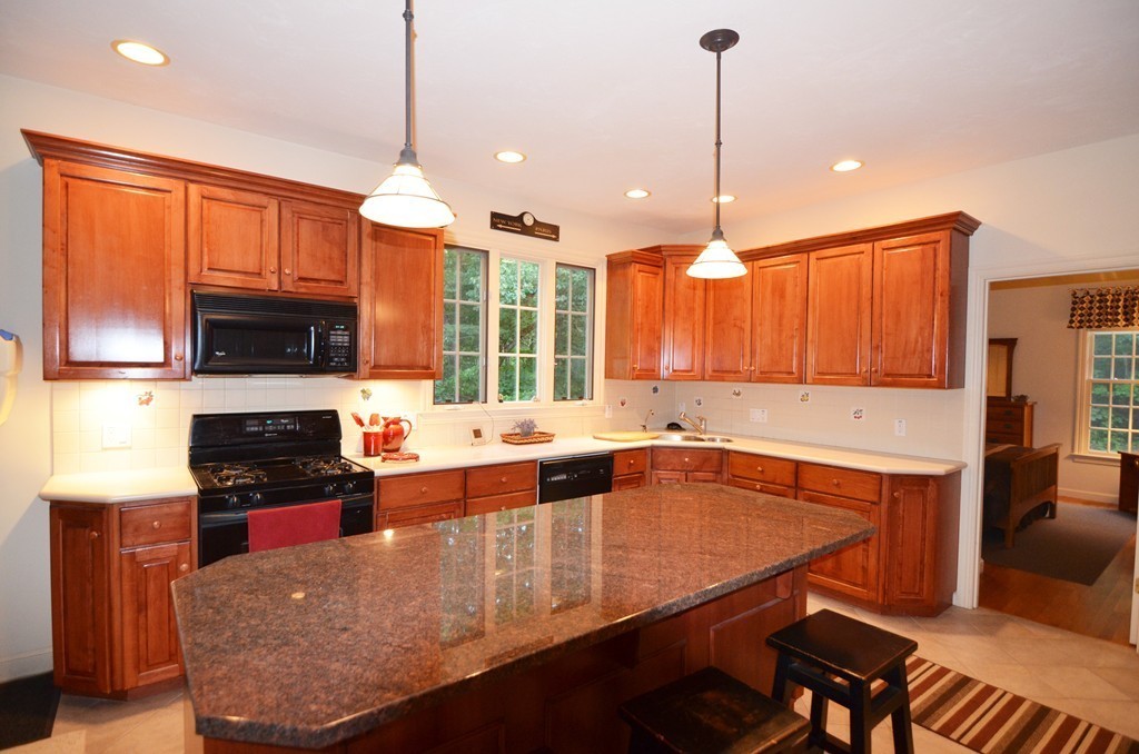 30 Mill Road Harvard, MA 01451 - Photo 4 of 21 a kitchen with stainless steel appliances granite countertop a stove a sink and a microwave