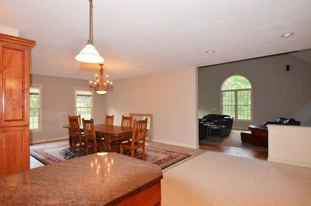 30 Mill Road Harvard, MA 01451 - Photo 6 of 21 a living room with furniture chandelier and a open kitchen view