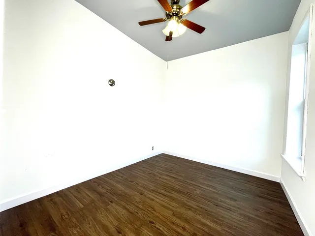 a view of a room with wooden floor